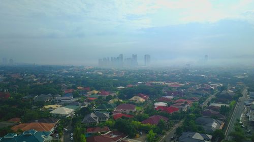 High angle view of buildings in city against sky