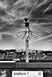 Information sign against sky