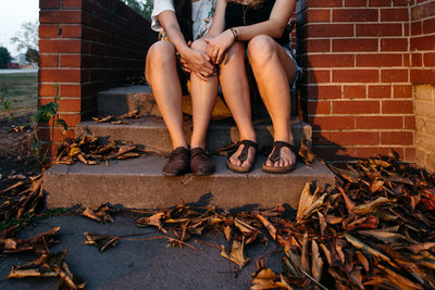 Low section of women sitting on steps