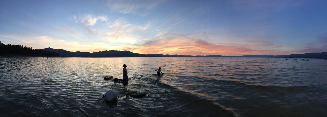 water, animal themes, sunset, sky, one animal, lake, bird, animals in the wild, silhouette, rippled, waterfront, tranquil scene, scenics, tranquility, beauty in nature, wildlife, nature, swimming, reflection, mountain