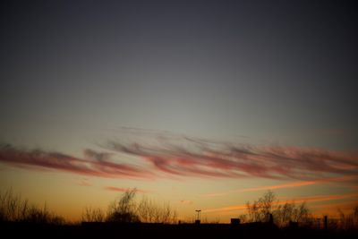 Silhouette landscape against sky during sunset