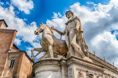 Low angle view of statue against cloudy sky