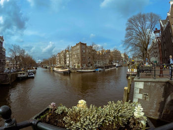 Boats in river with buildings in background