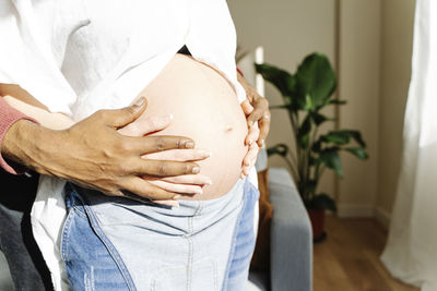 Close-up of a husband hugging the belly of his pregnant wife. parenthood concept