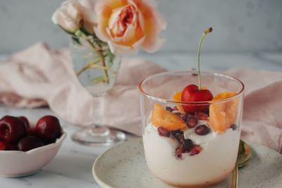 Close-up of fruits and yoghurt in glass on table