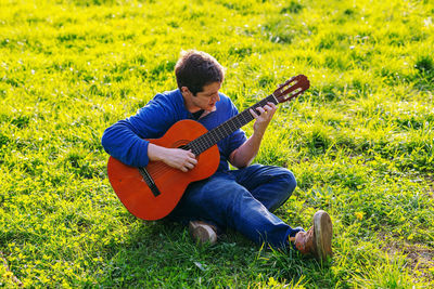 Man playing guitar on land