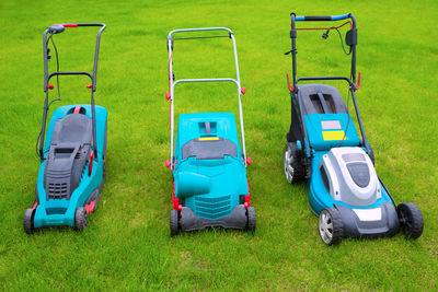 Lawn mowers standing in the backyard in a sunny summer day, a close-up