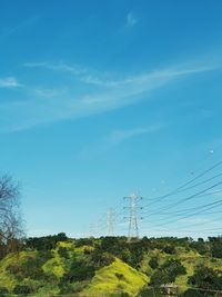 Low angle view of electricity pylon against sky