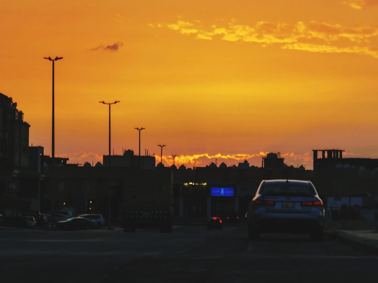 CITY STREET AGAINST ORANGE SKY