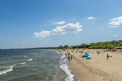 People on beach against sky