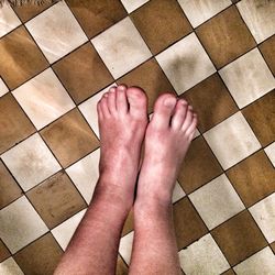 Low section of woman on tiled floor