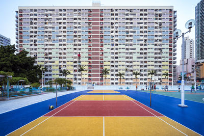 Playing field against buildings in city