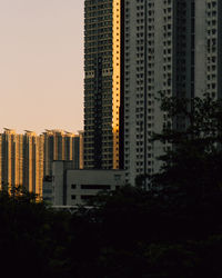 Buildings in city against clear sky