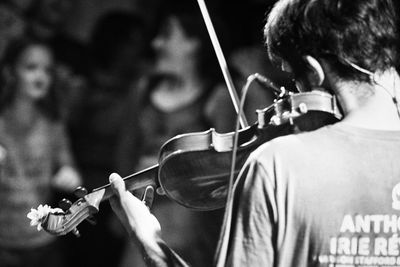 Close-up of man playing guitar