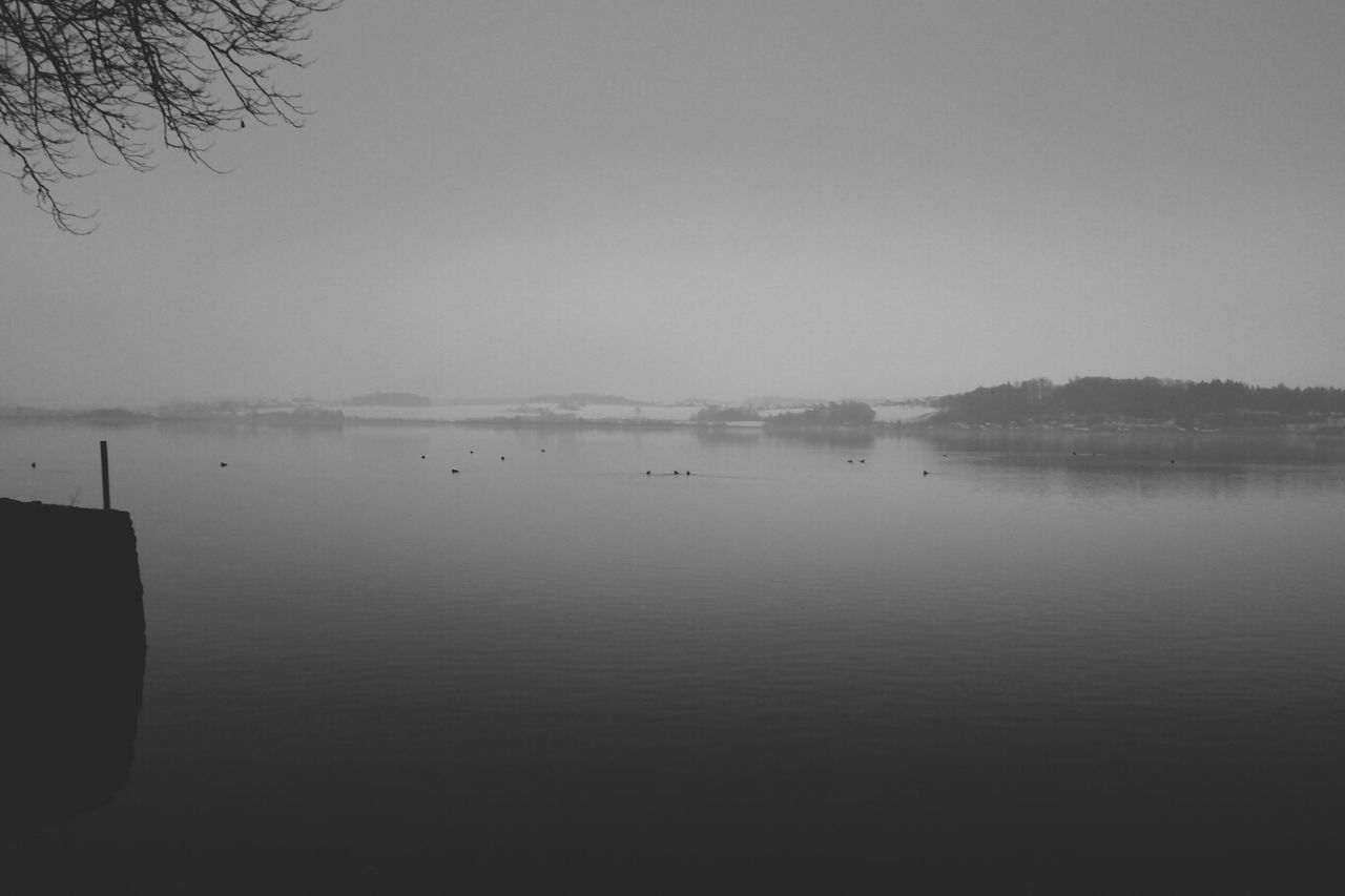 water, clear sky, tranquil scene, tranquility, copy space, lake, scenics, waterfront, nature, beauty in nature, nautical vessel, reflection, tree, river, sea, calm, transportation, sky, boat