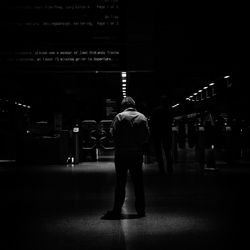 Full length of woman standing in illuminated city at night