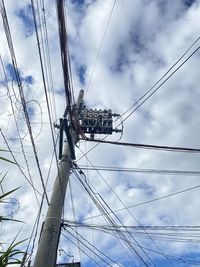 Low angle view of electricity pylon against sky
