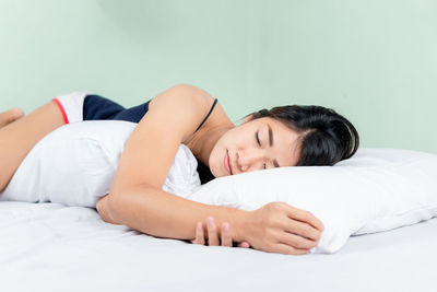 Young woman sleeping on bed