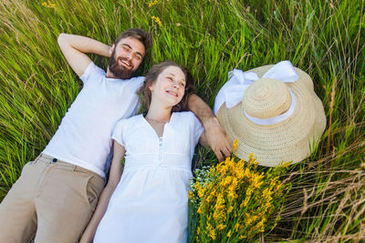 Portrait of smiling young couple standing against plants