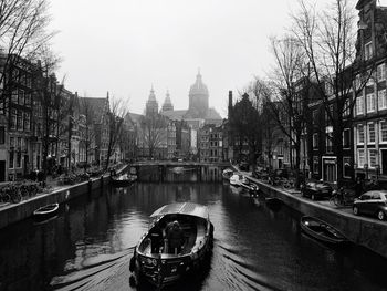 Boats in canal along buildings