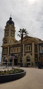 Low angle view of church against cloudy sky