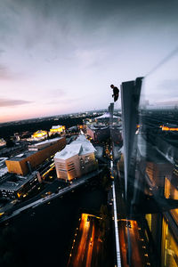 High angle view of illuminated cityscape against sky at dusk