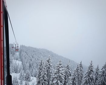 Overhead cable car against sky during winter