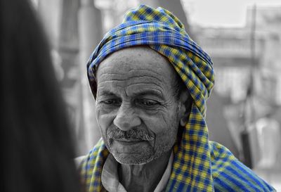 Close-up of thoughtful mature man looking down while standing outdoors