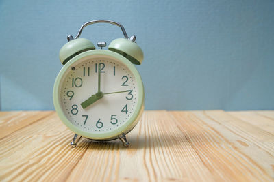 Close-up of clock on table at home