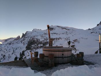 Built structure against snowcapped mountains against clear sky