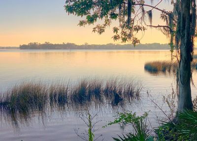 Scenic view of lake against sky during sunset