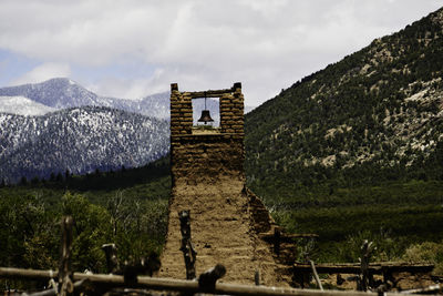 Church against mountain range against sky