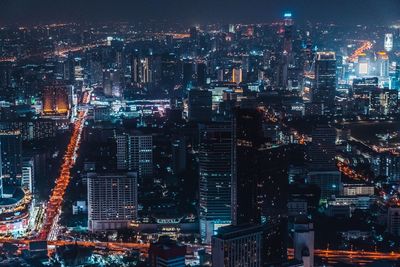 Aerial view of illuminated buildings in city at night