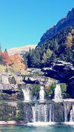 Scenic view of river against clear blue sky