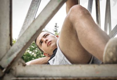 Young man lying down outdoors