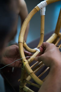 Close-up of man making wooden chair