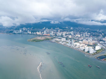 High angle view of buildings against cloudy sky