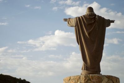 Low angle view of statue against sky