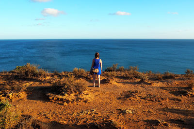 Rear view of man standing on beach