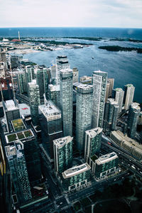 High angle view of buildings by sea against sky