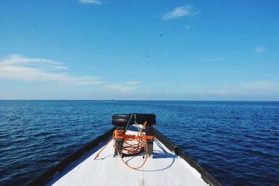 Boat on sea against blue sky