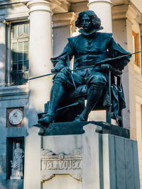 Close-up of statue against building in city