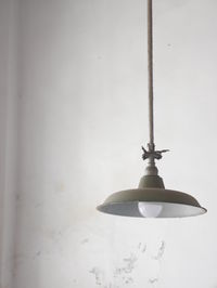 Close-up of electric lamp against wall