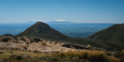 Scenic view of mountains against blue sky