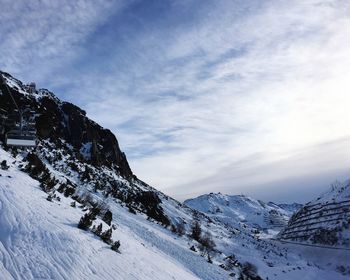 Scenic view of snow covered mountains against sky