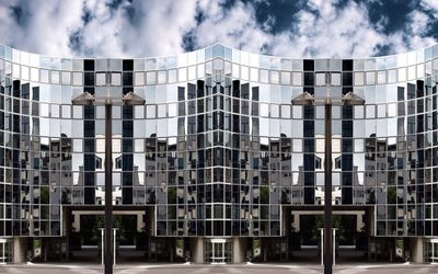 Low angle view of buildings against cloudy sky