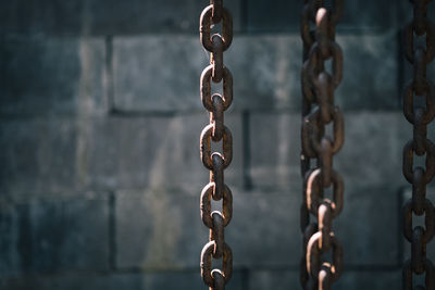Close-up of chain against wall