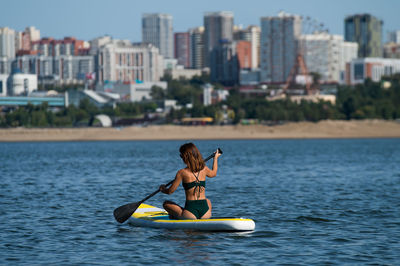 Man kayaking in sea