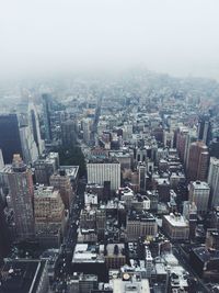 Cityscape against sky during foggy weather