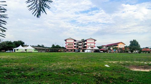 Houses on field against sky